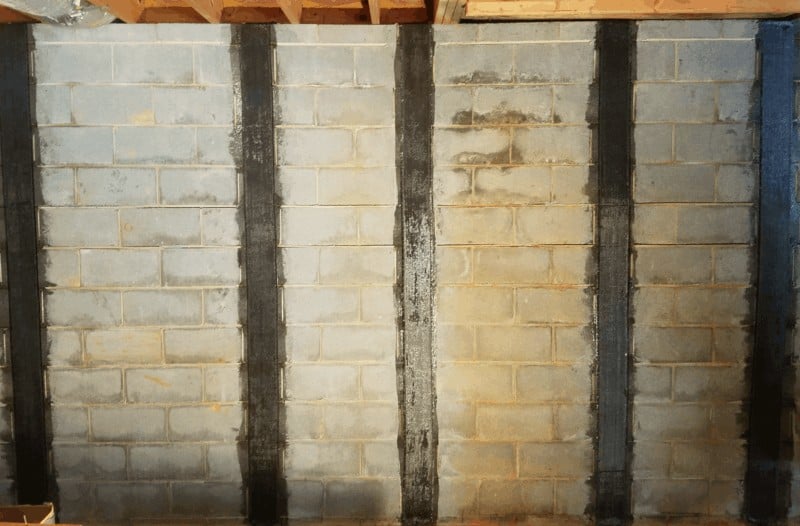 Adhesive used in basement wall repair services is painted on cinderblock.