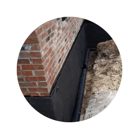 An Exterior French Crawl Space Drainage System protecting a building's foundation.