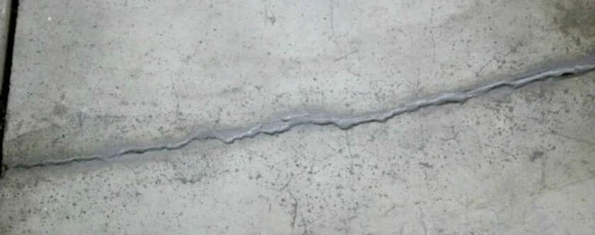 A crack on concrete needing concrete slab repair.