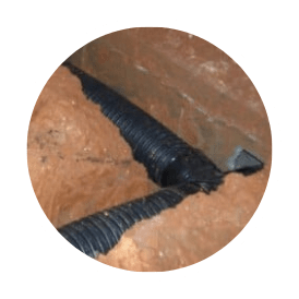 A crawl space drainage system connects at two pipes and runs through a building's foundation.