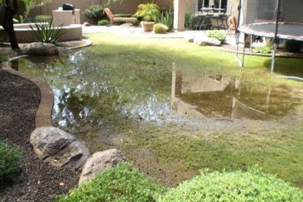 A backyard flooded with standing water.