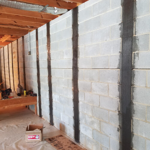 Basement wall repair is in process on cinderblock walls.