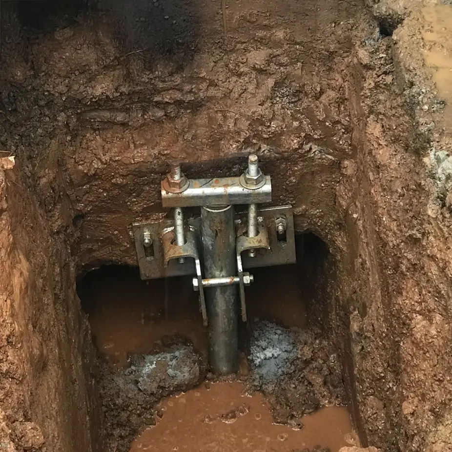 Helical Pier Installation - Professional foundation repair beneath a house